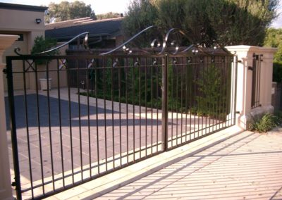 contemporary-design-automated-inwardly-opening-dual-driveway-steel-gates-painted-black-and-mounted-between-two-pillars