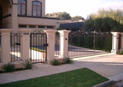 contemporary-design-automated-inwardly-opening-dual-driveway-steel-gates-with-single-entrance-gate-and-panelled-fence-the-three-gates-with-feature-scrolls-on-top