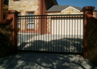 contemporary-design-automated-opening-and-sliding-double-driveway-steel-gates-mounted-between-two-pillars