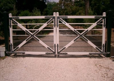 farmhouse-design-double-driveway-automated-steel-gate-featuring-black-painted-corner-and-diagonal-joining-brackets-with-vermin-proof-mesh-attached